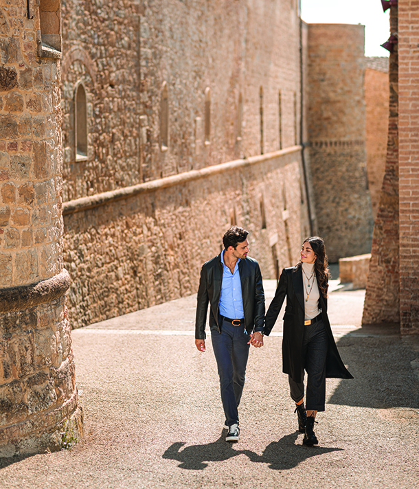 Couple walking through Castelfalfi village