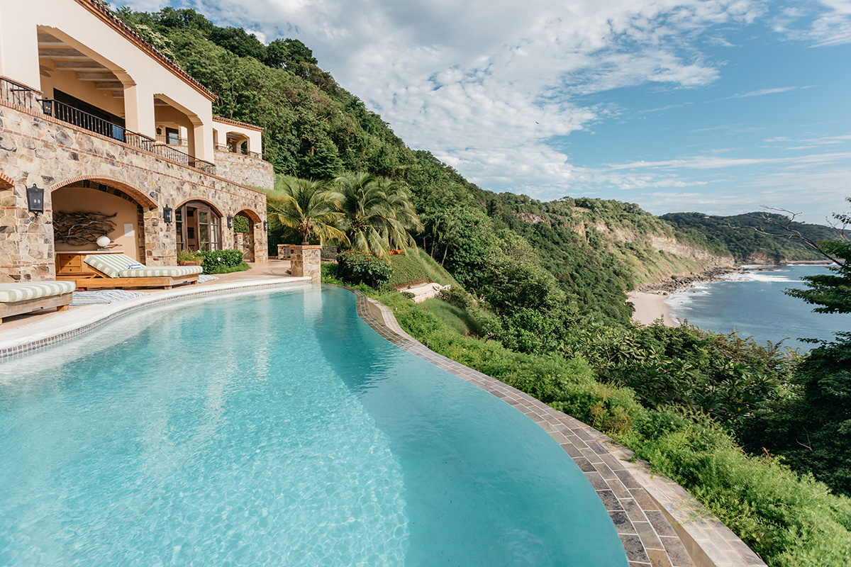 Luxurious estate located on Nicaragua's Emerald Coast, Rancho Santana, with patio deck and large infinity swimming pool on cliff overlooking ocean.