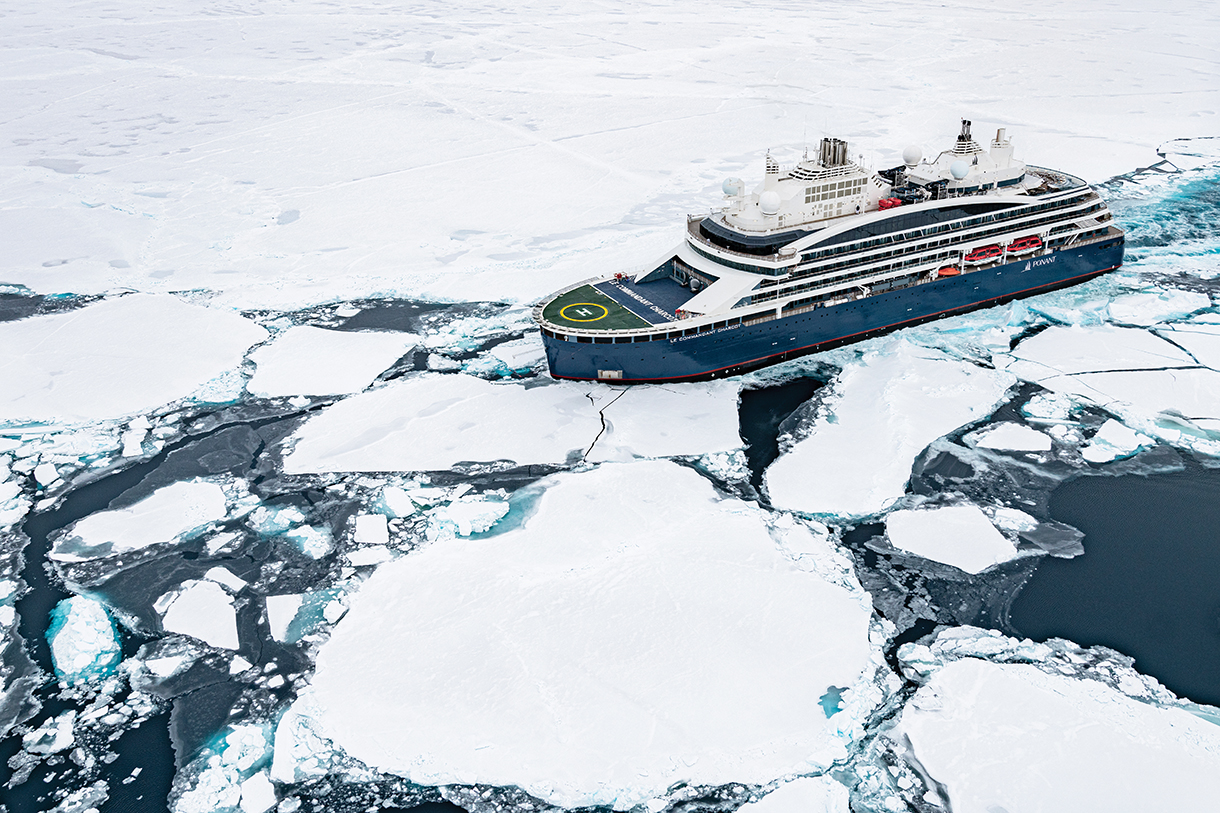 Closeup of luxury icebreaker cruise ship navigating through ice-covered artic waters