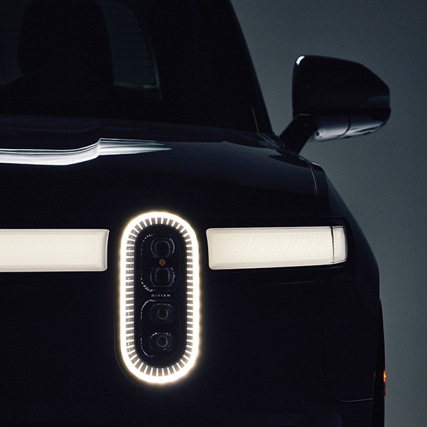 Closeup of Rivian R1T’s front headlight turned on  