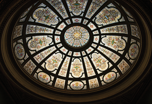 The large, stained art glass dome in The Grand Army of the Republic rotunda is a grand and iconic attraction at the Chicago Cultural Center. 