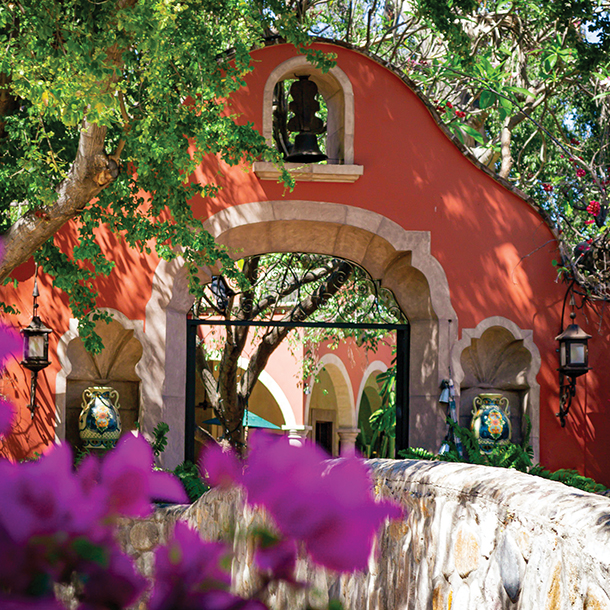 A colorful archway to an entrance of a hacienda property. The Spanish architecture is an elegant patchwork of colonial mansions from the 17th century. 