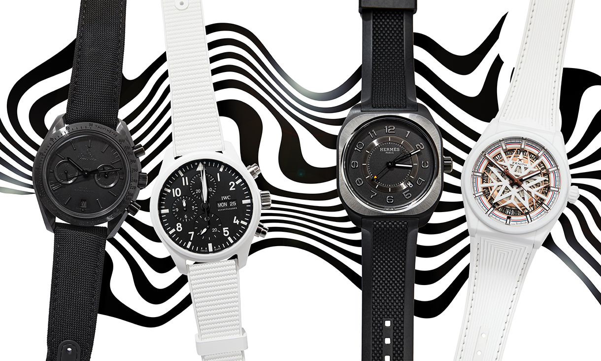 Two white and two black watches on top of wavy design background 