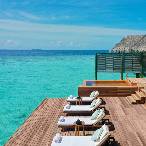 An overwater resort spa with a relaxation deck and outdoor plunge pool overlooking the ocean