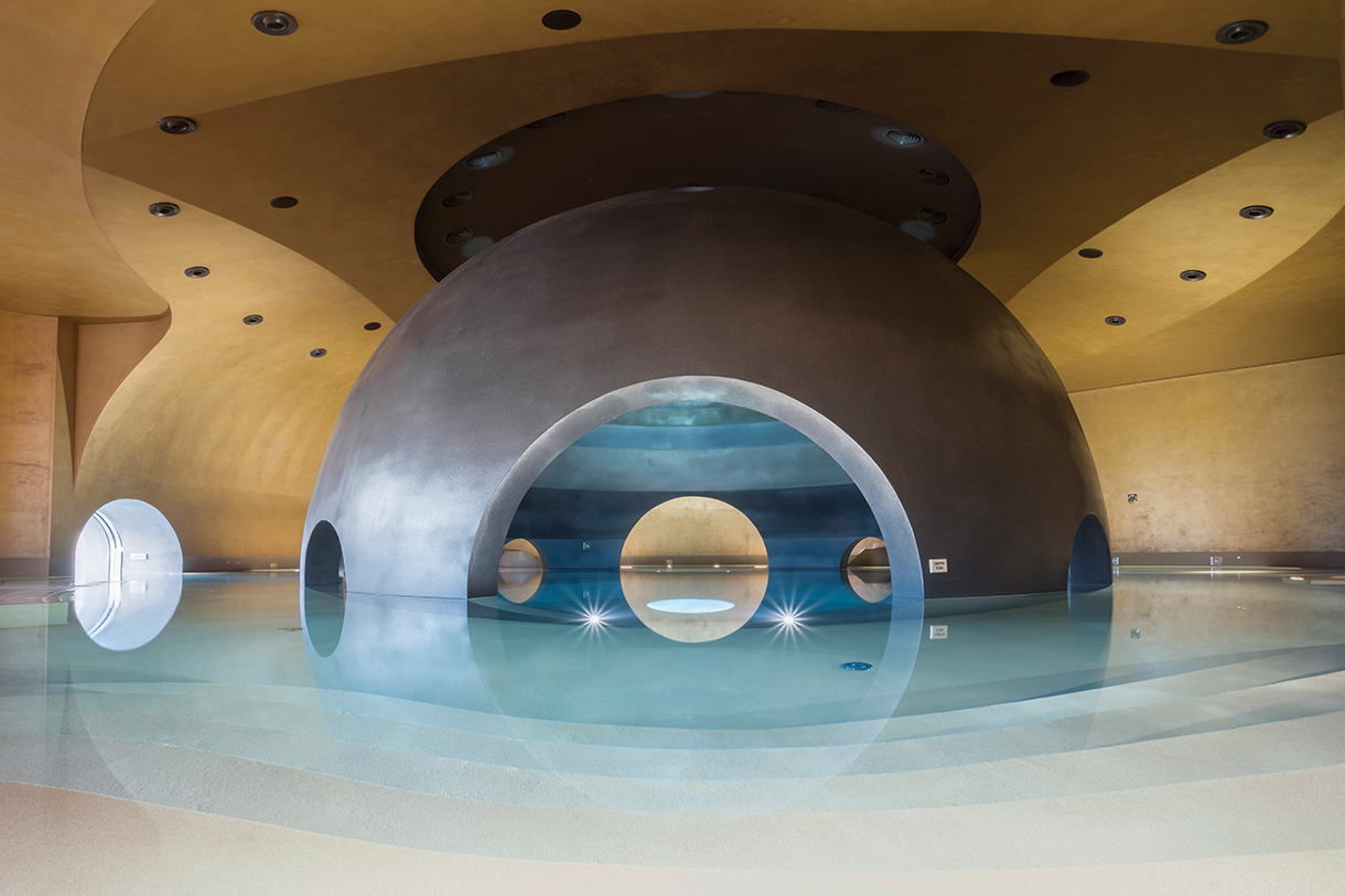 Interior of avant-garde sphere pool with dome-shaped stone walls