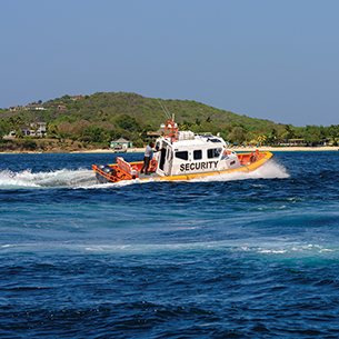 Security boat inspecting and patrolling the waters surrounding the remote and private island of Mustique