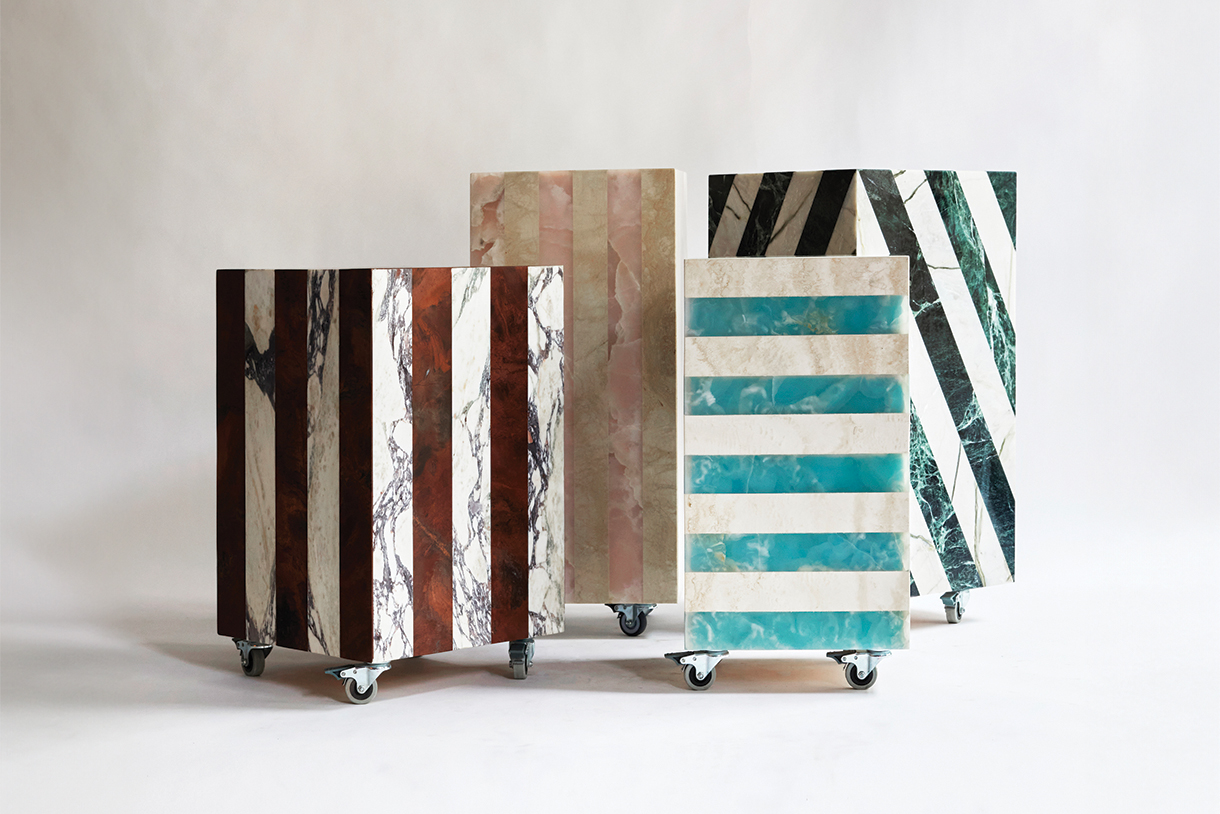 Four square side tables with different marble patterns and colors. The tables have wheels and are arranged on a white background.