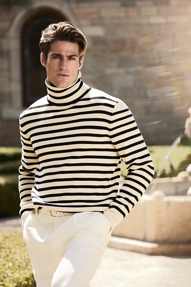 Man wearing black and white horizontal striped long sleeve turtleneck sweater with white pants
