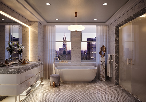 A luxurious ensuite bathroom with high-end finishes and patterned marble flooring. There is a bathtub next to a window with a city view, gray marble double sink vanity, and double glass doors to a shower room. 