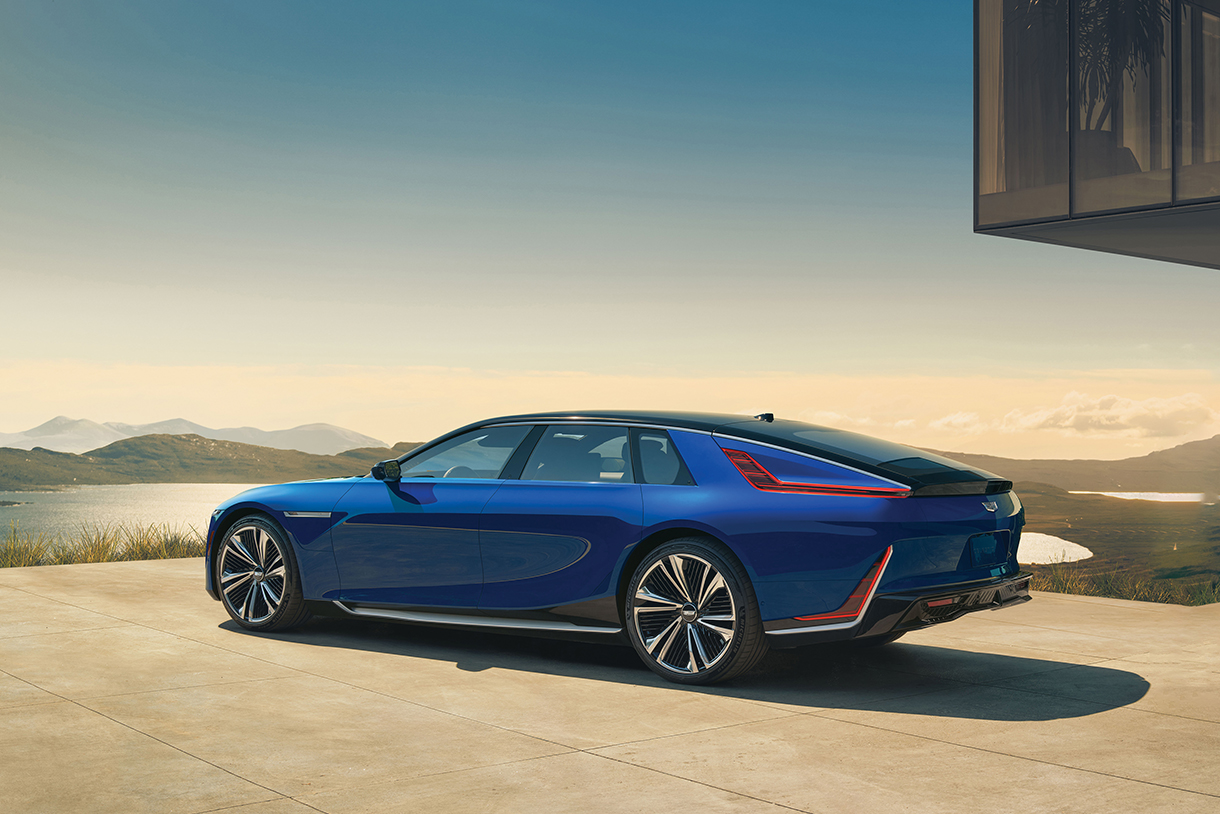 A side view of a blue 2024 Cadillac Celestiq parked in front of a building on a concrete driveway