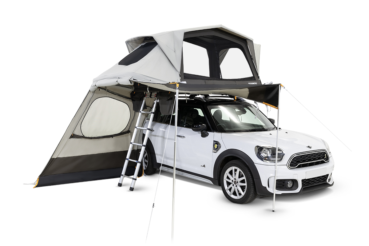 Dometic TRT 140 AIR rooftop tent on top of a compact car. Made of a breathable polycotton material, the tent is outfitted with mesh windows and an integrated foam mattress.