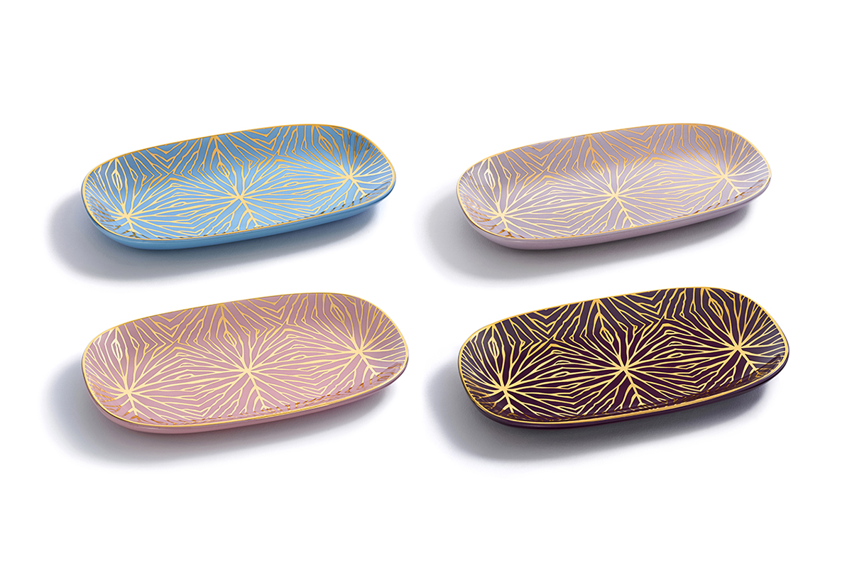 Anna Rabinowicz and Talia Fine of Talianna Home create a new collection of tableware. The 4 colorful trays feature gold accents that represent a lily pad's veins. 