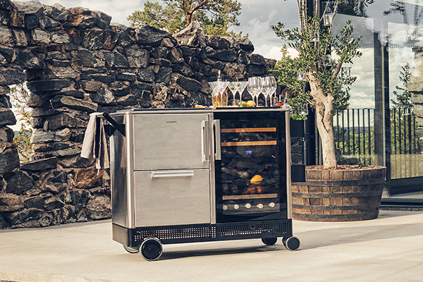 Outdoor mobile bar cart with heavy-duty wheels and ergonomic handle, features a dual refrigerator, plus roomy a barware cabinet, prep board, and serving tray. 