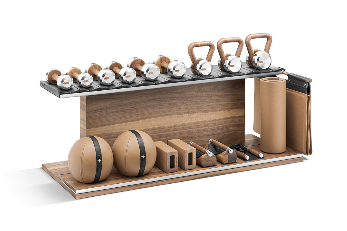 Pent gym equipment founded by Polish entreprenuer featuring a wooden bench and essential accessories.The dumbbells, kettlebells, and jump ropes available in stainless steel or bronze with black or brown leather trim.