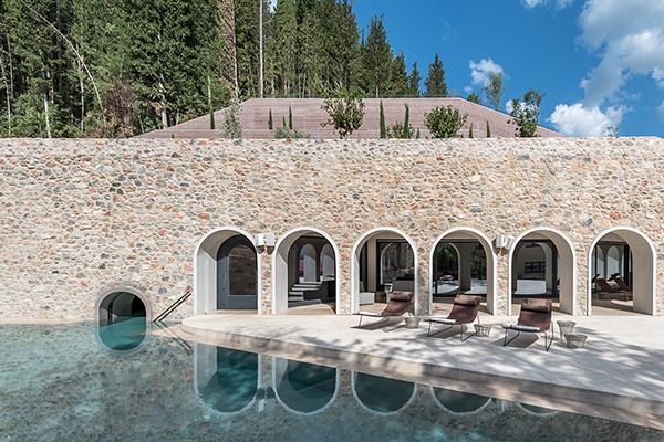 An outdoor pool area at Euphoria Retreat, a wellness retreat located in Mystras, Greece.
