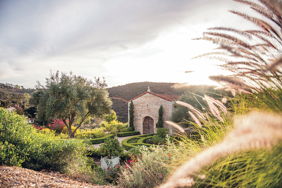 A small stone building with a terracotta tile roof in the center of a landscaped garden at Cal-a-Vie Health Spa in Vista, California.