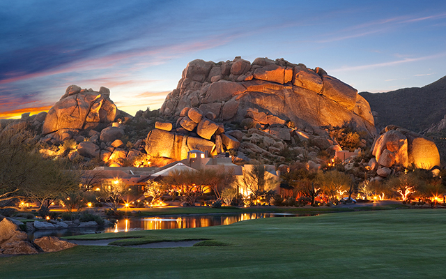 A luxury resort complex with a large, natural rock formation in the background, Scottsdale Boulders Resort & Spa in Scottsdale, Arizona.